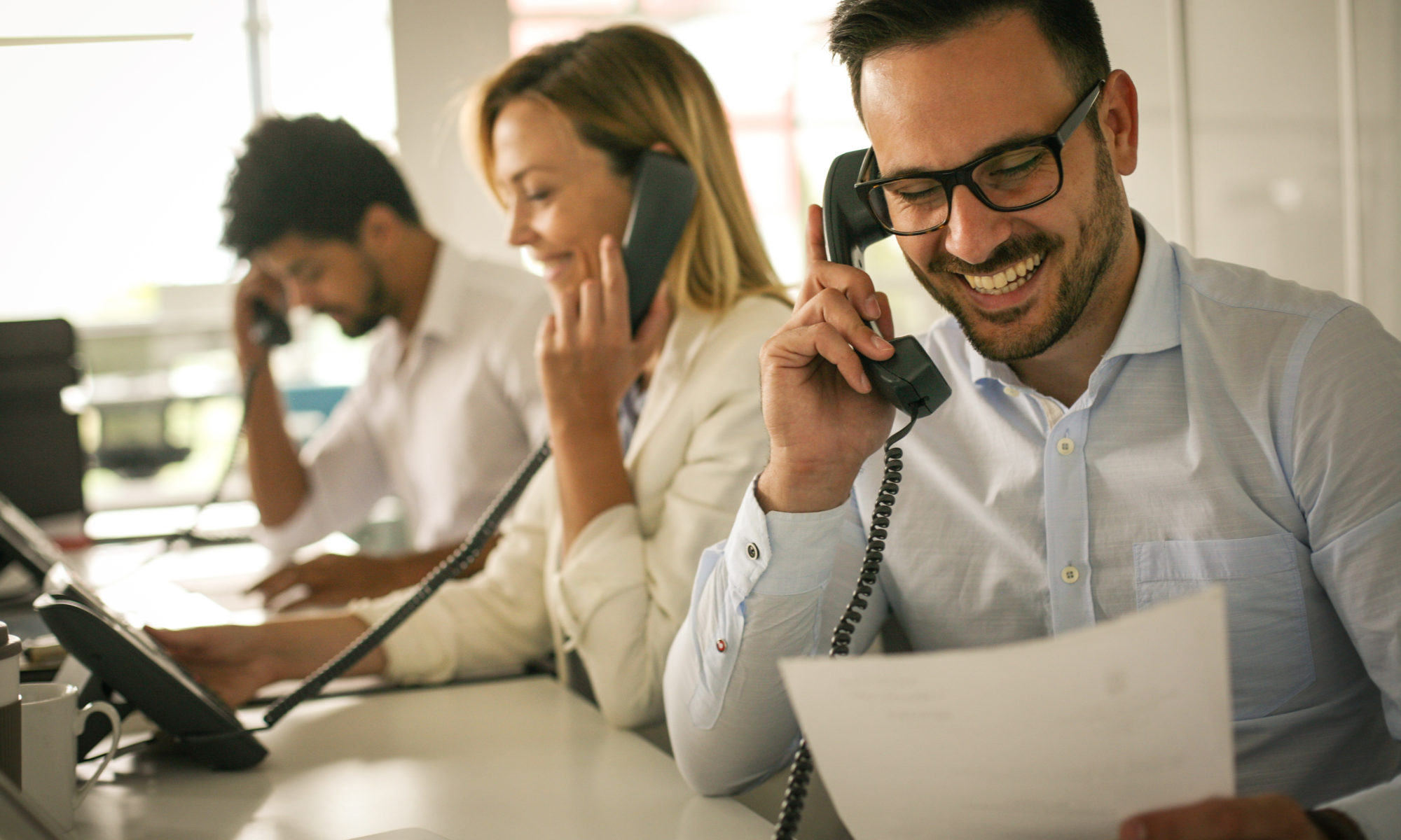 People in operations center  talking on Landline phone. Operators in the office.