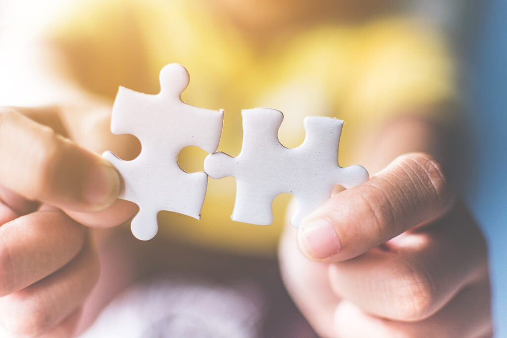 Strategic management and business solutions for success, Hand connecting jigsaw puzzle