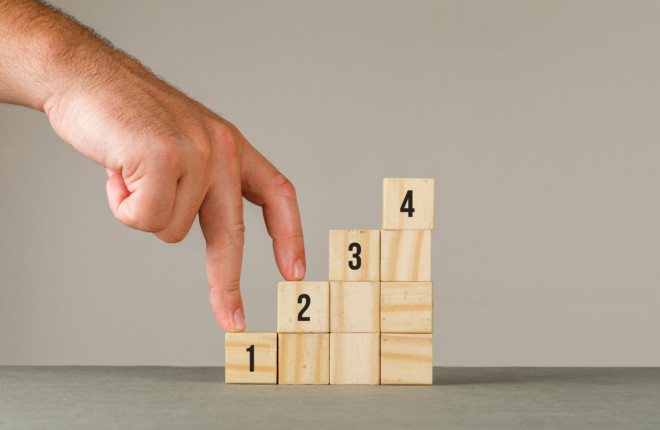 Business strategy concept on grey and white background side view. man putting fingers on step stairs.